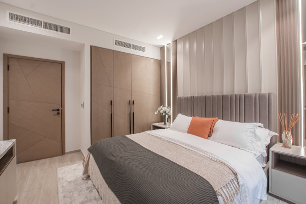 Elegant modern bedroom with neutral tones and stylish decor elements for a cozy ambiance.